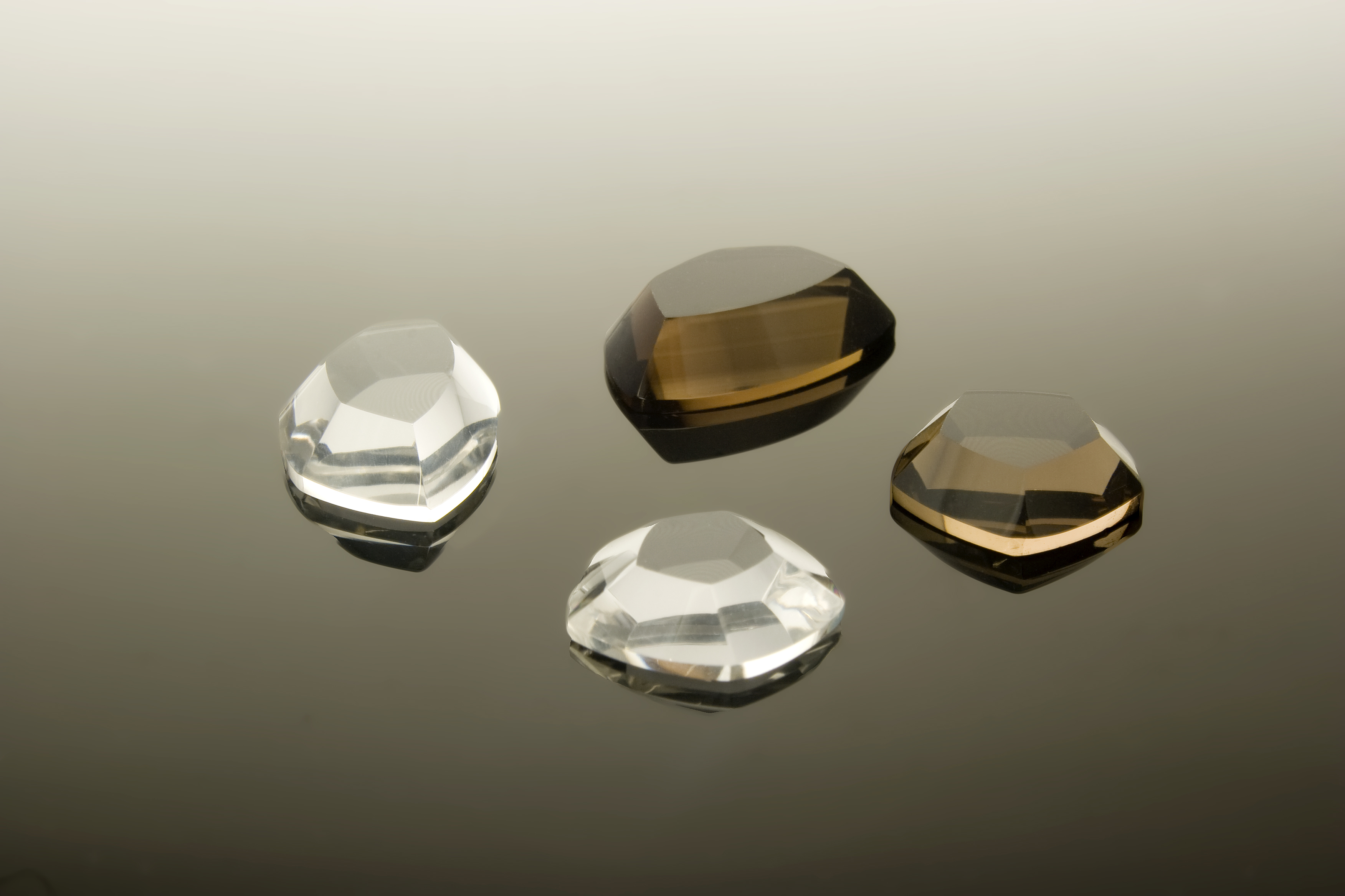 Real faceted gemstones photographed on a reflective surface